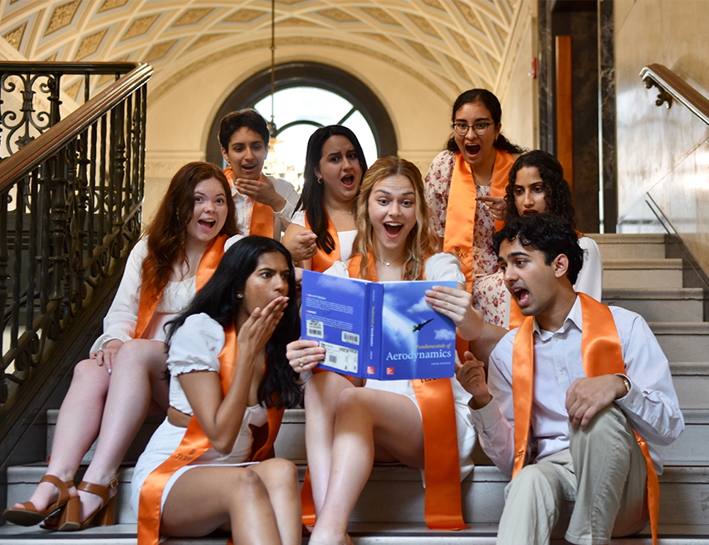 senior students looking at text book